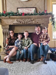A photo of Jennie Clausen and her sons Ben, Andy and Nathan, and her husband, Jason, posing for a photo.